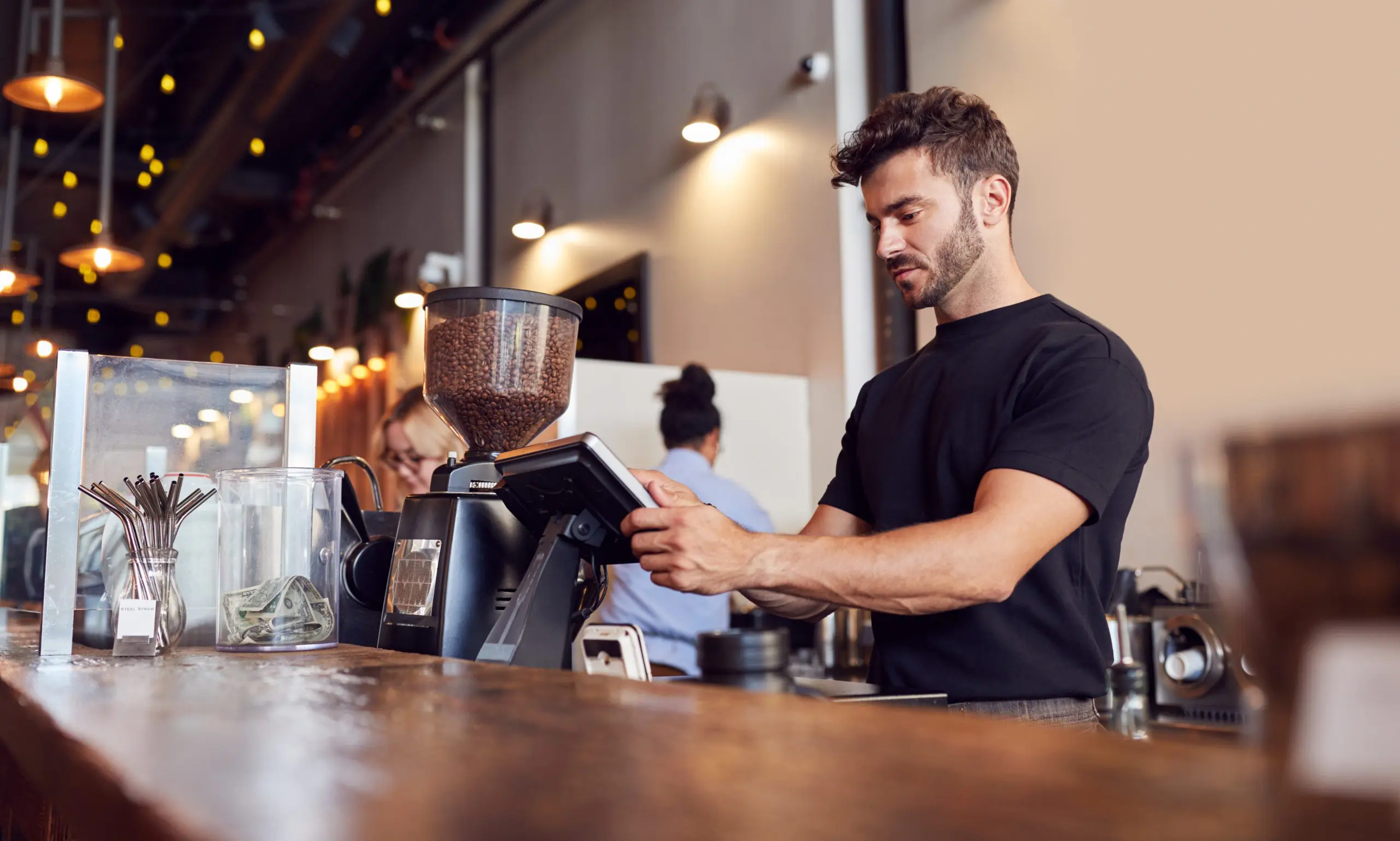 SecurOS® POS 6 | male coffee shop owner working behind sales desk 2024 10 19 02 54 03 utc scaled e1731077656470 Image link